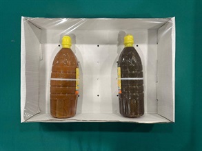 Hong Kong Customs seized about 264 kilograms of suspected liquid methamphetamine with an estimated market value of about $140 million in Fanling on May 29. Photo shows the suspected liquid methamphetamine disguised in chili sauce packaging seized by Customs officers (right).