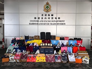 Hong Kong Customs on June 28 seized about 7 400 suspected counterfeit goods and eight litres of suspected duty-not-paid liquor at the Tuen Mun River Trade Terminal Customs Cargo Examination Compound. The total estimated market value was about $1.5 million, with a duty potential of about $70,000. Photo shows the suspected counterfeit goods and suspected duty-not-paid liquor seized.