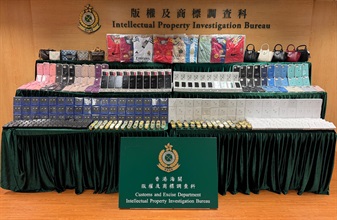 Hong Kong Customs conducted a two-week joint operation with the Mainland and Macao Customs from November 18 to 30 to combat cross-boundary and transshipment counterfeiting activities. During the operation, Hong Kong Customs detected 26 cases and seized about 36 000 items of suspected counterfeit goods, including mobile phone accessories, watches, jerseys and handbags, with a total estimated market value of about $11 million. Photo shows some of the suspected counterfeit goods seized.