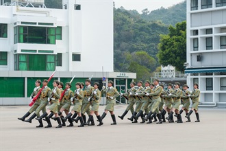 Hong Kong Customs held a graduation parade for the Customs Youth Leader Corps Winter Training Camp 2024 and "YES Buddy" AI Robot Launching Ceremony at the Hong Kong Customs College today (December 27). Photo shows the Foot Drill and Flag Party of the Customs Youth Leader Corps performing the flag-raising ceremony.